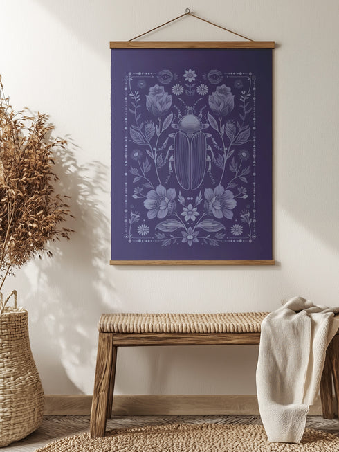 A symmetrical wall tapestry in monochromatic navy blue featuring a detailed scarab beetle surrounded by flowers and botanical elements, mounted on a wooden dowel with natural twine.